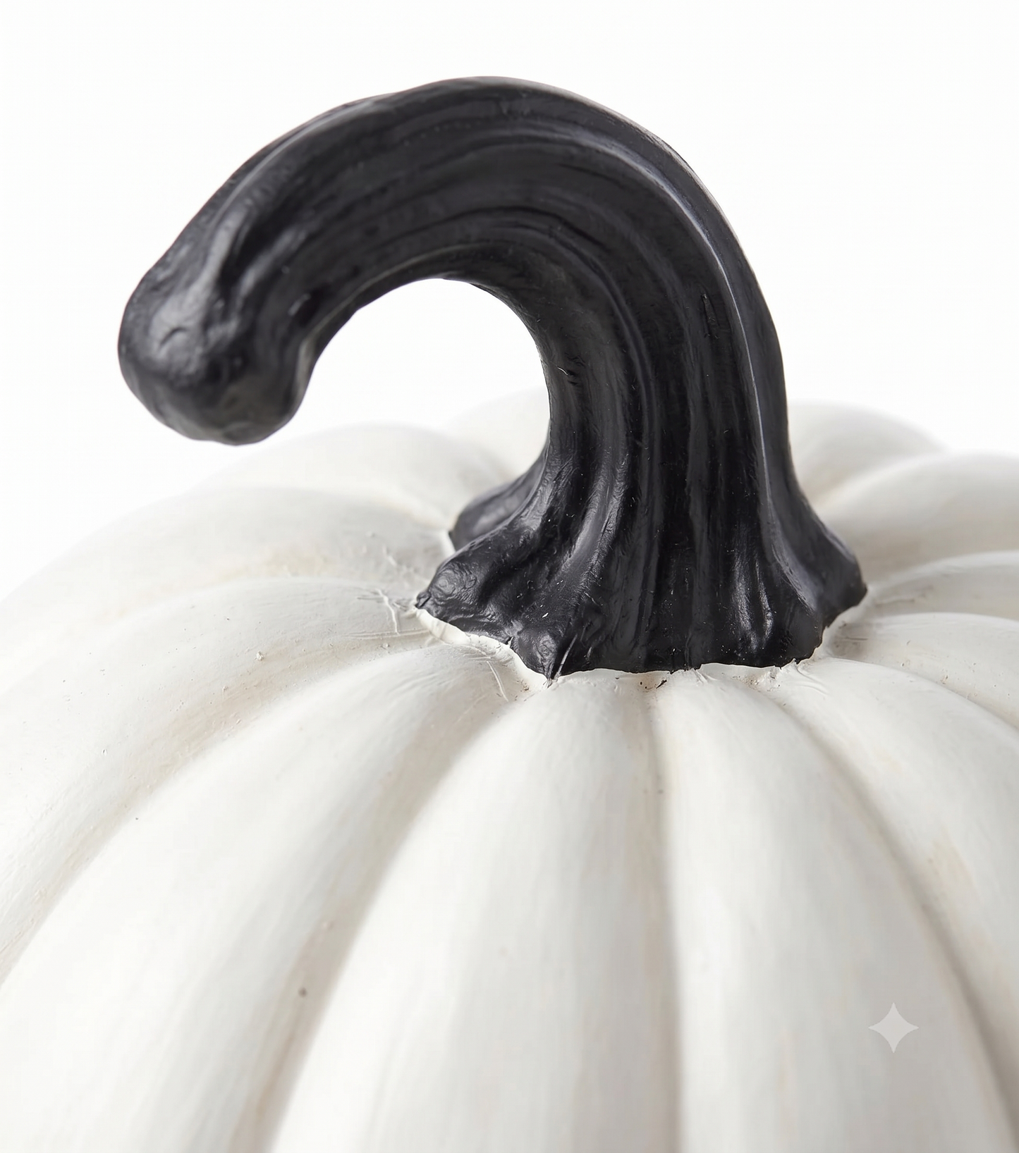 Side angle close-up showing the smooth white vertical ribs and detailed black ornate frame edges of the resin Halloween pumpkin decoration
